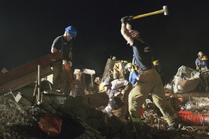 U.S. Air Force firefighters break away concrete during a search for survivors in the remains of Plaza Towers Elementary School in Moore, Okla.