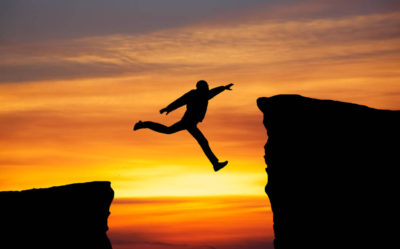 man jumping across gap