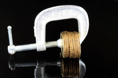 Budget Crisis US Currency Gold Coins in Vise Clamp